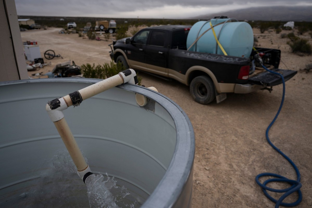 Water gushes into a homeowner's reservoir during a water delivery in 2024 in Terlingua. Most Texans rely on water from utilities. In some remote parts of the state, like Terlingua, residents have water delivered. The state's water supply is under duress from a number of threats including overuse and outdated infrastructure.