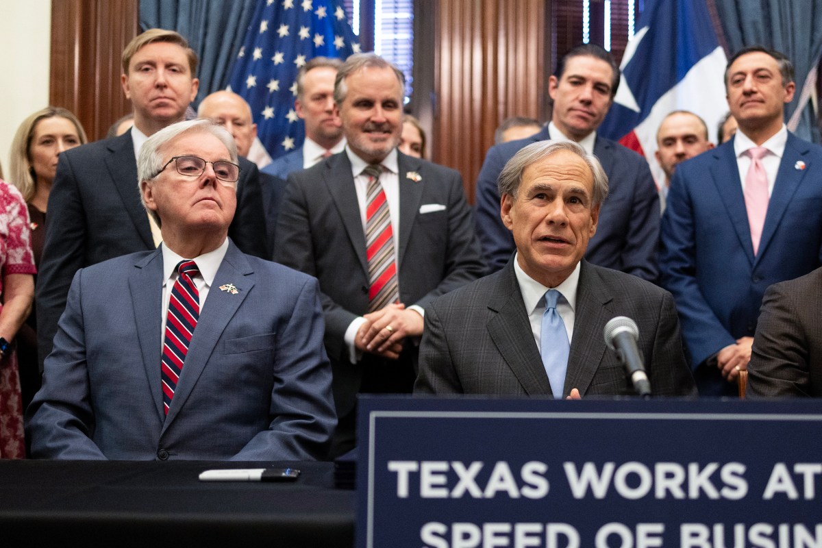 Gov. Greg Abbott, right, speaks alongside Lt. Dan Patrick during a bill signing event, creating the Texas Stock Exchange on May 14, 2025.