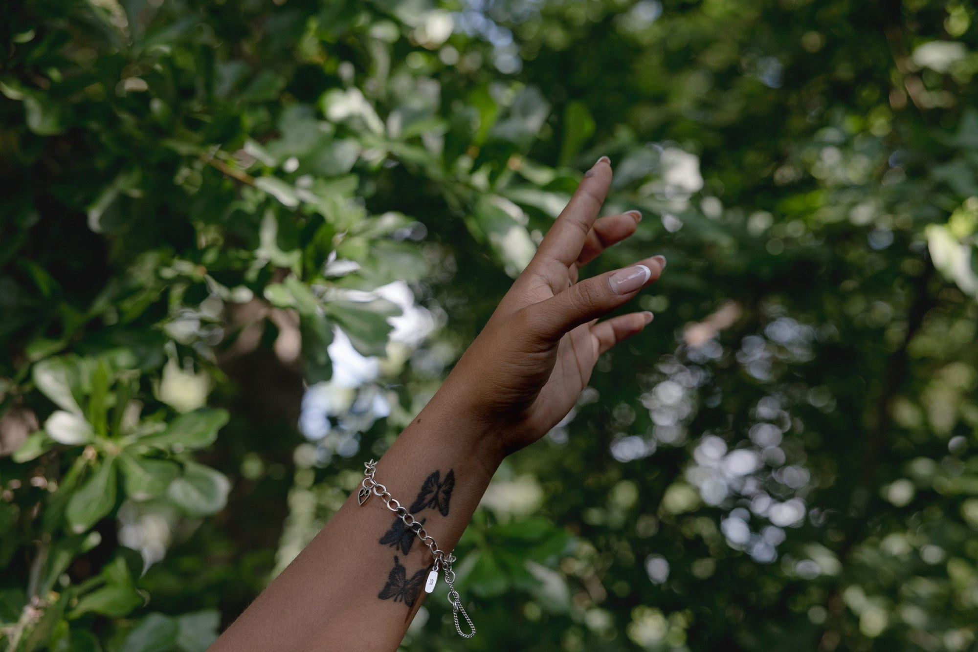 Lisbet Avila visits clients’ homes to send updates to her landscaping team in May. After helping her parents with their landscaping business, Lisbet started her own with her father’s blessing.