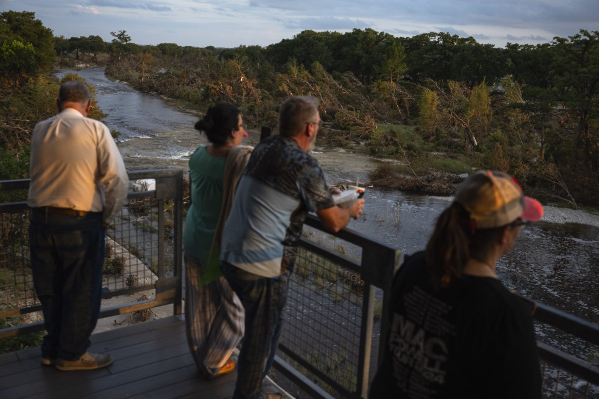 People gather at pavilion overlooking the Guadalupe River following a vigil for the victims of the Kerr County flood on July 11, 2025, in Kerrville.