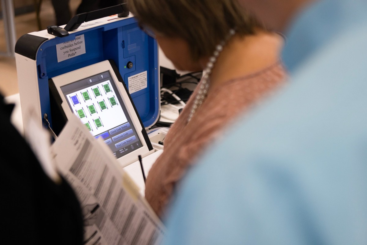 People test the polling equipment at the Hays County election office on Sept. 18, 2024.