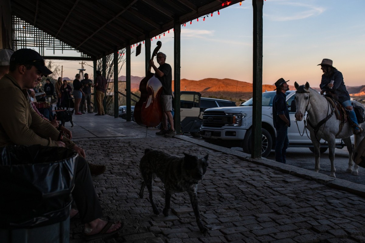 South Brewster County residents and tourists congregate on the porch of the Terlingua Trading Company in December.