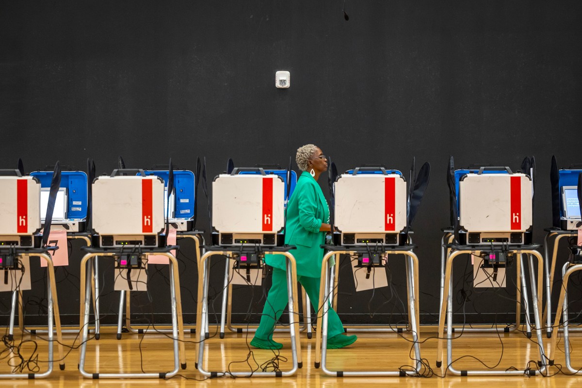 An election worker makes a final passthrough of voting machines on Election Day at Parker Elementary in Houston on Nov. 5, 2024.