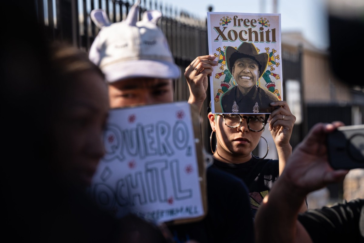 Protesters hold signs up during a rally for the release of Catalina “Xochitl” Santiago, a DACA recipient who was detained by immigration agents at El Paso's airport, outside of an immigration detention center in El Paso on Sept. 10, 2025.