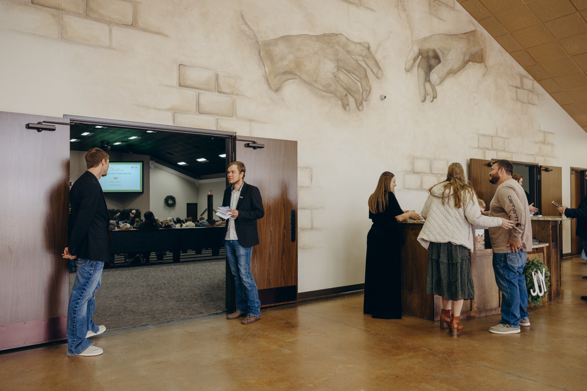 Ushers wait at the doors of the Mennonite Evangelical Church in Seminole before the German service on Nov. 30, 2025.