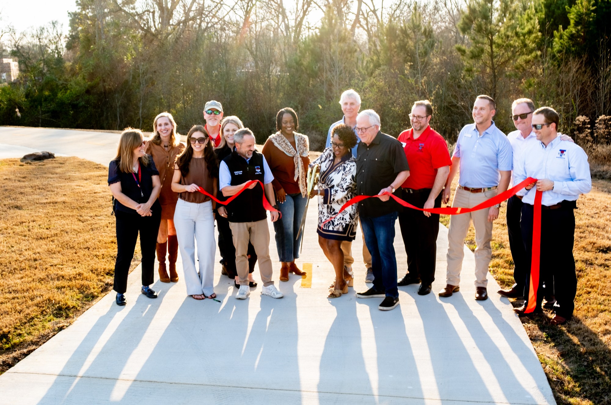 City and chamber of commerce officials cut the ribbon during a ribbon cutting ceremony for a new section of the Legacy Trails walking trail on Jan. 6, in Tyler.