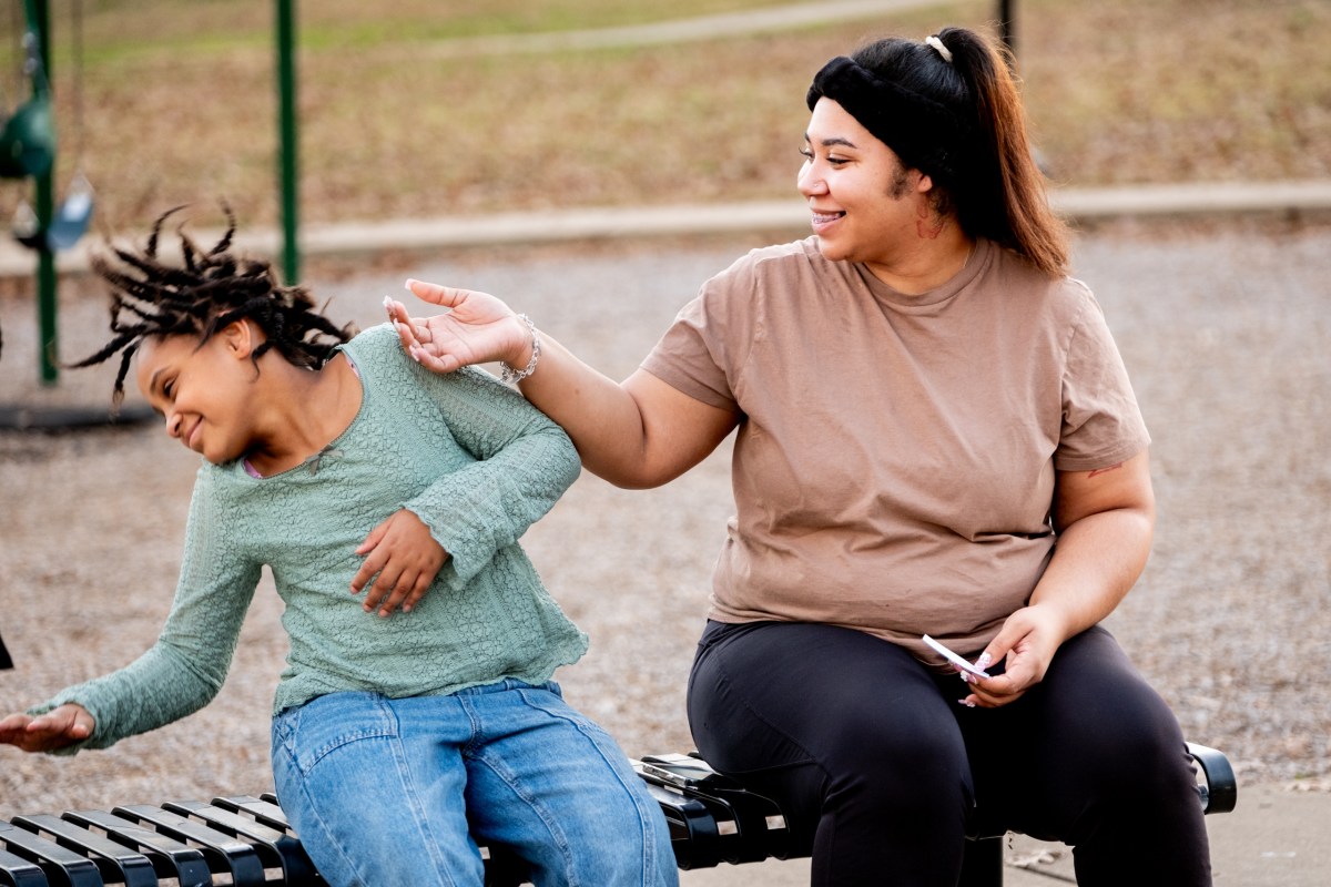Andrea Tucker and her daughter Marciella, 8, spend their evening on a bench at Bergfeld Park as her twin daughters Jhene and Javeya play, on Jan. 6, in Tyler.