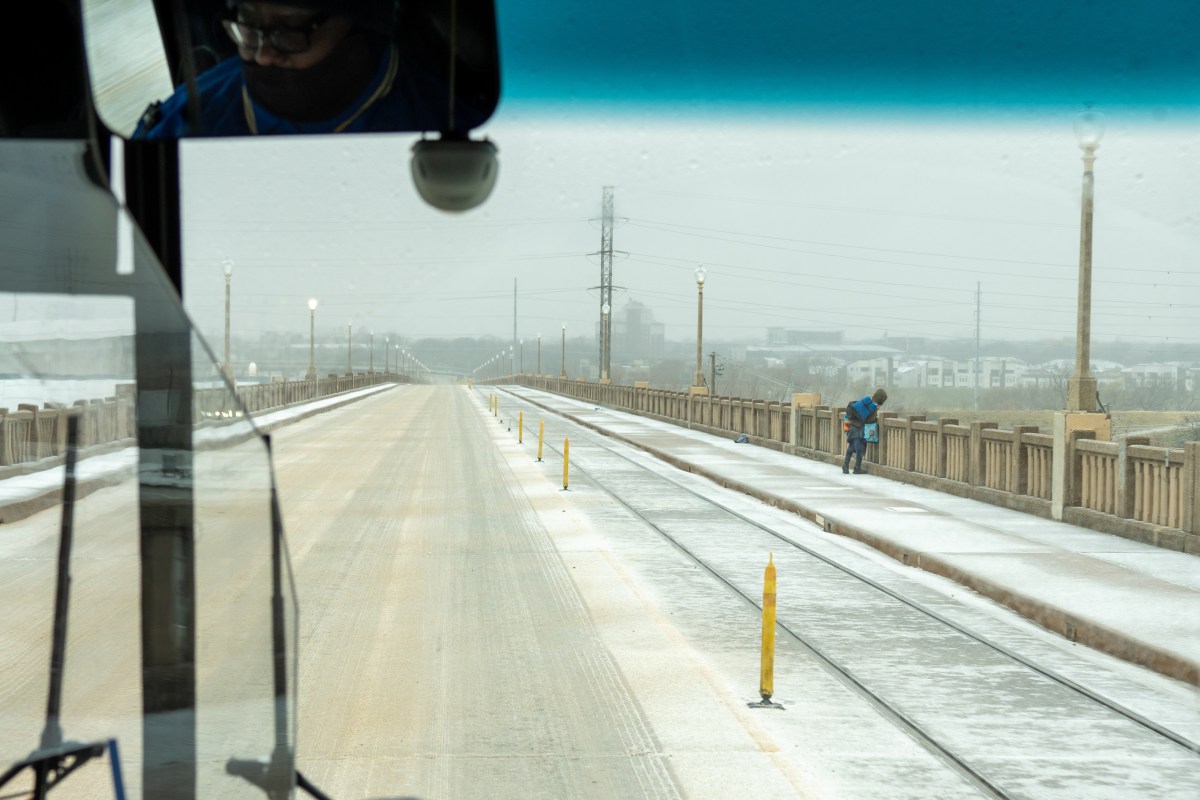Bus driver Paul Johnson drives his DART bus over an icy overpass in Dallas on Jan. 24, 2026.