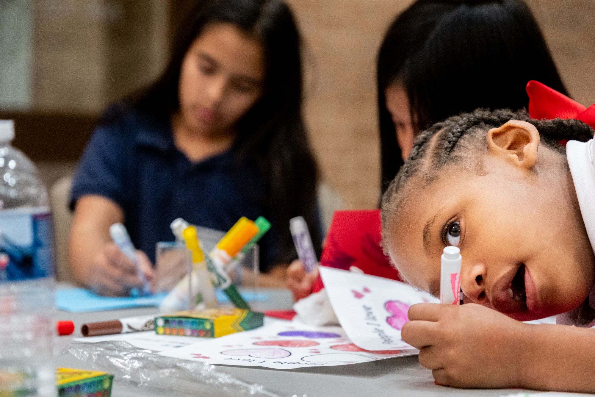 Anais Brooks spends her evening making Valentine's cards as her mother attends a SHINE community support group meeting for mothers,on Feb. 9, at Marvin Methodist Church in Tyler.