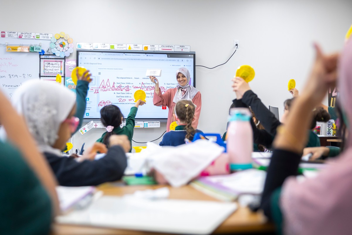Teacher Sarra Benramdane helps students practice reading at Iman Academy in southwest Houston on Wednesday, March 4, 2026. Iman Academy was accepted into the Texas voucher program in late March, after a federal judge extended the student application deadline.