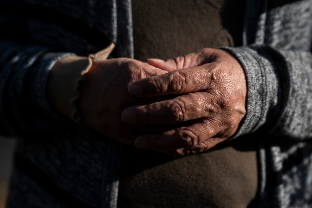 A 54-year-old woman from Edinburg holds her hands as she poses for a photo at her home in the Rio Grande Valley on March 18, 2026. After suffering a bad fall in October, she refused to go to the hospital over fears she could be deported.