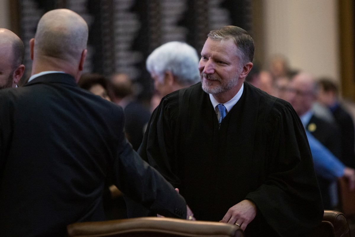 Then-Texas Supreme Court Justice Jeff Brown talks with legislators after the State of the Judiciary address at the Texas Capitol in Austin on Feb. 6, 2019.