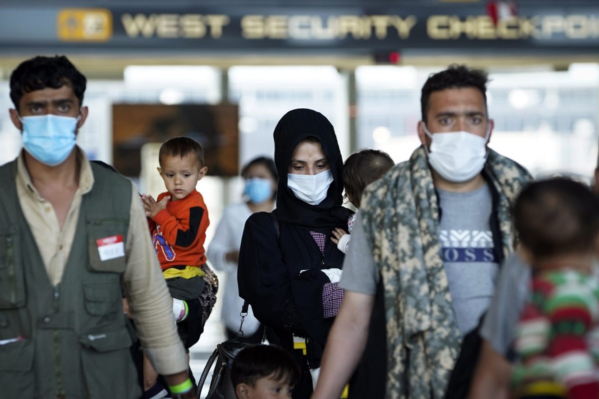 Afghan refugees arrive at Dulles International Airport in Northern Virginia while en route to military facilities in the U.S. on Aug. 26, 2021.
