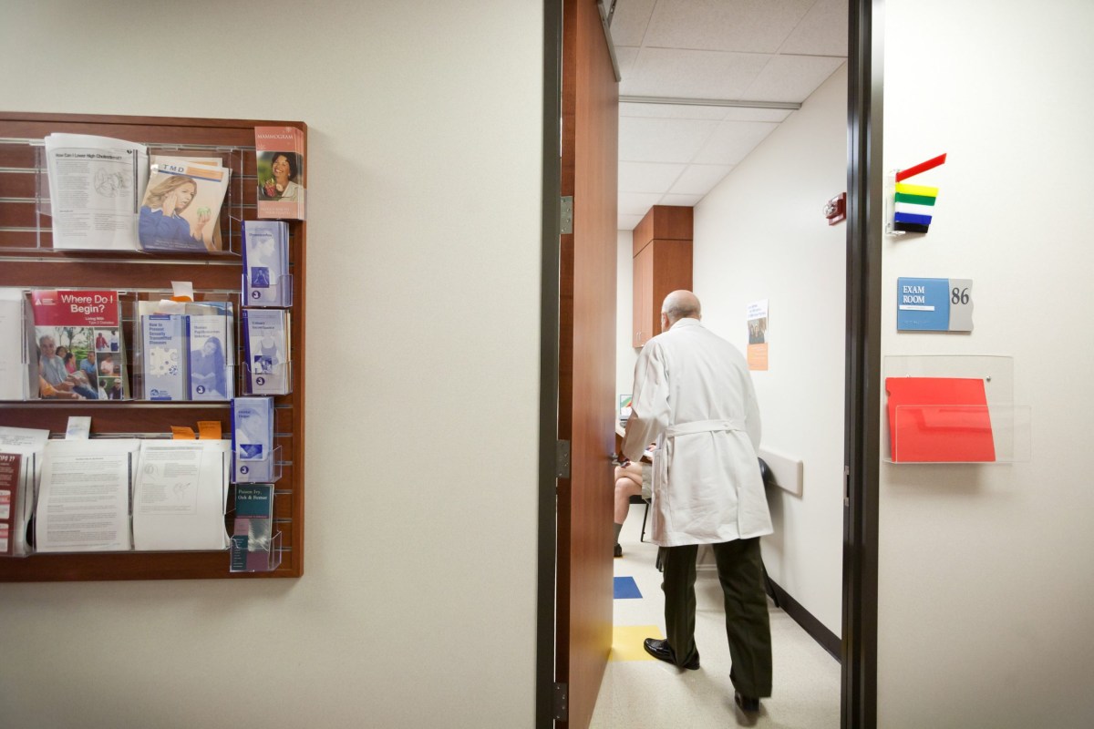 Dr. Spencer R. Berthelsen visits with patient Francisco Garcia, a fellow physician, before his annual physical at their clinic in Sugar Land on Sept. 22, 2011.
