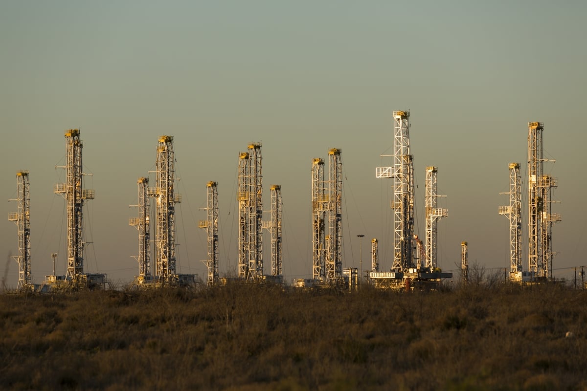 Dozens of stacked oil drilling rigs sit in a yard just north of Interstate 20 between Midland and Odessa.