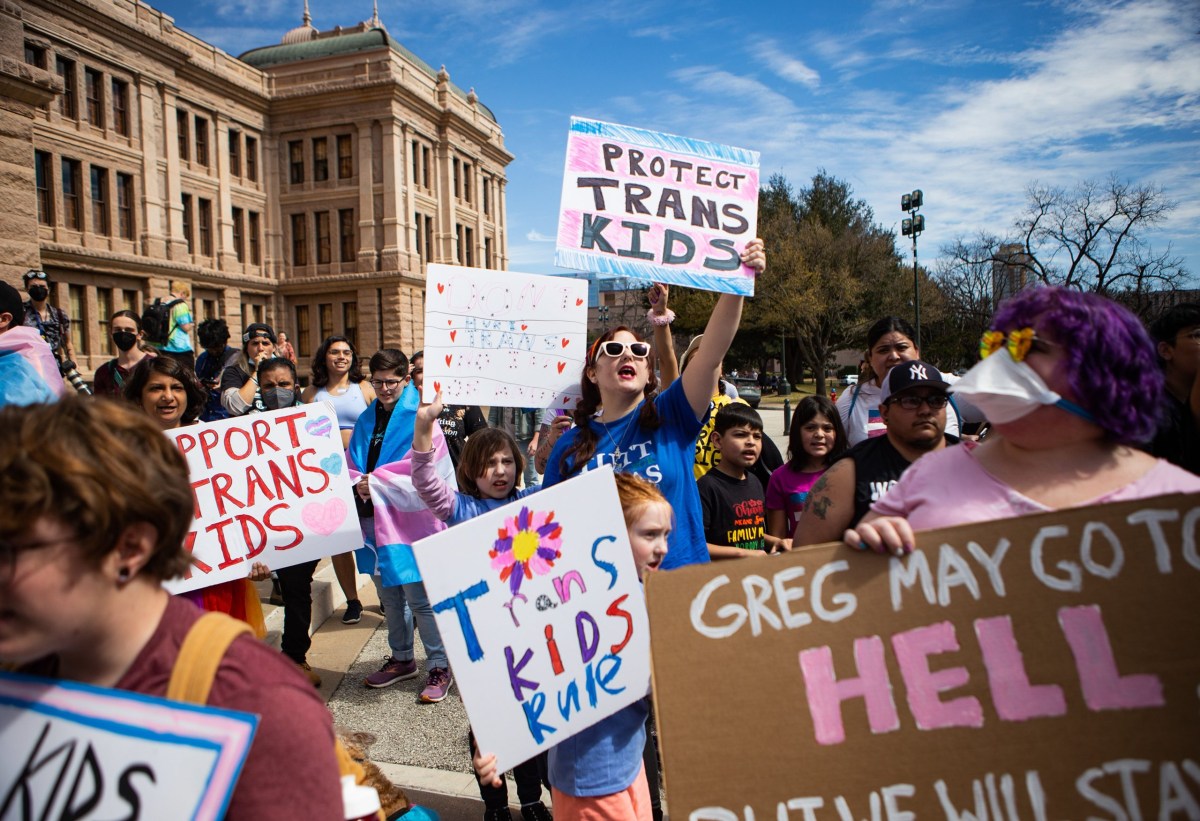 Protesters opposing bills that would limit transgender kids’ access to puberty blockers and hormone therapies rally at the Texas Capitol on March 1.