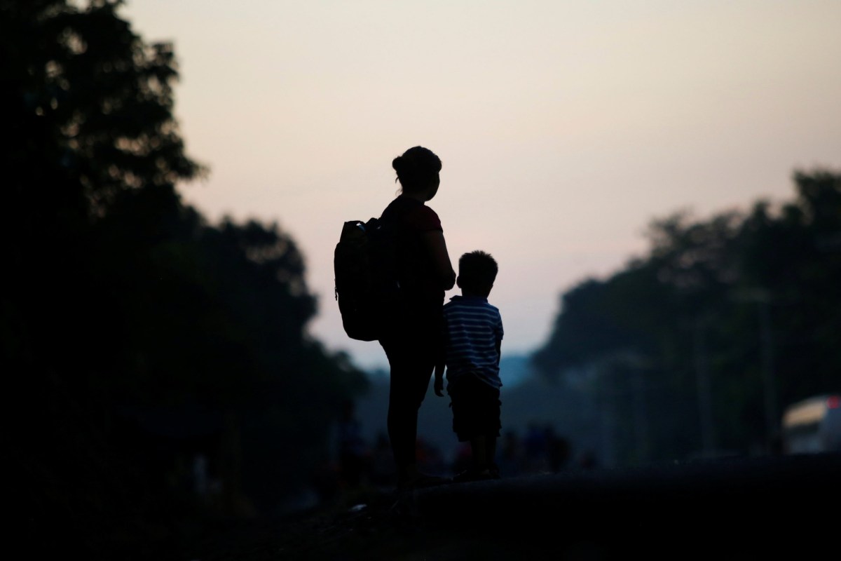 A migrant from El Salvador and her son take part in a caravan heading to the U.S. border, near Huixtla, Mexico November 27, 2021.